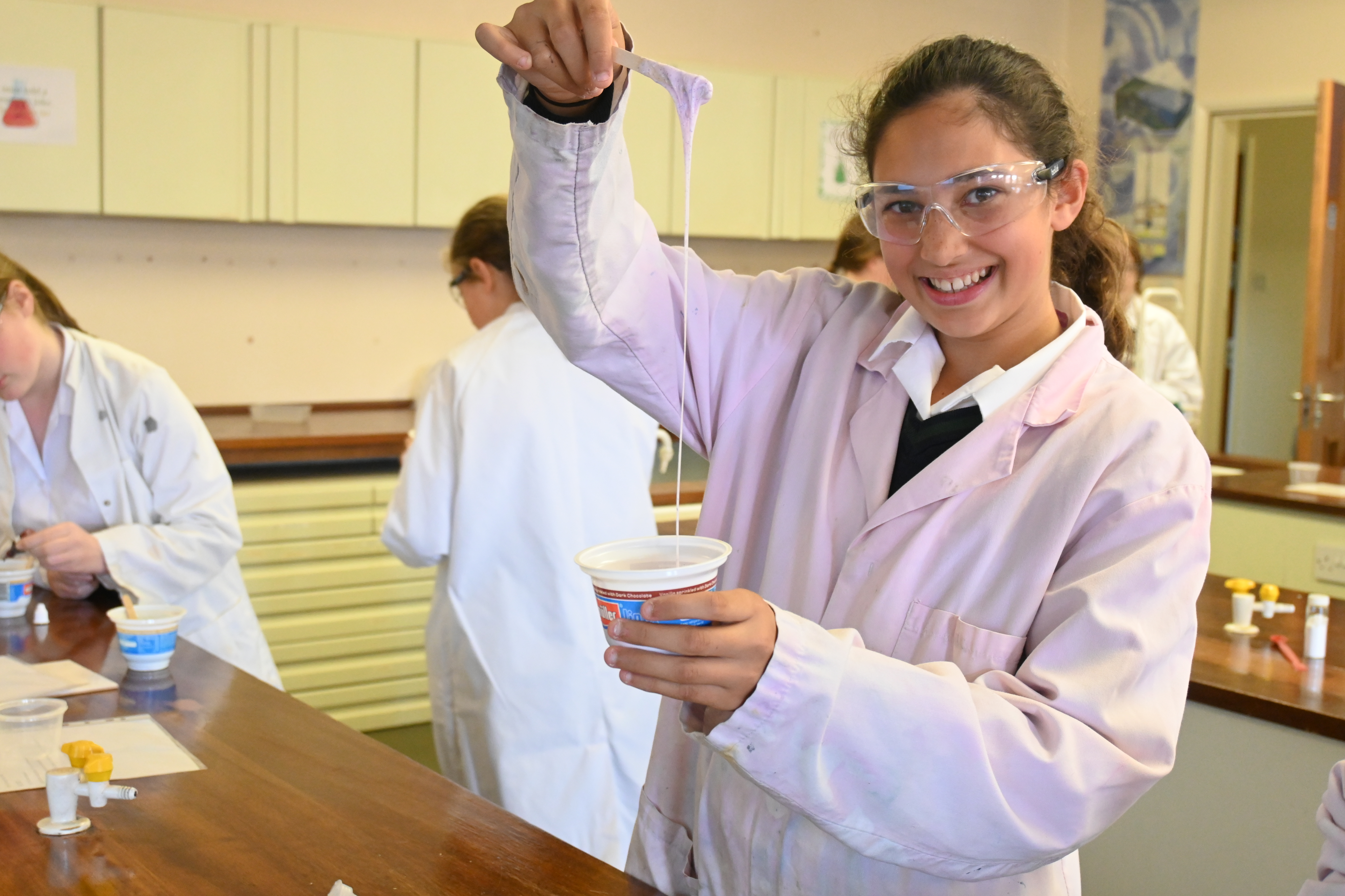 Girl smiling in a lab coat