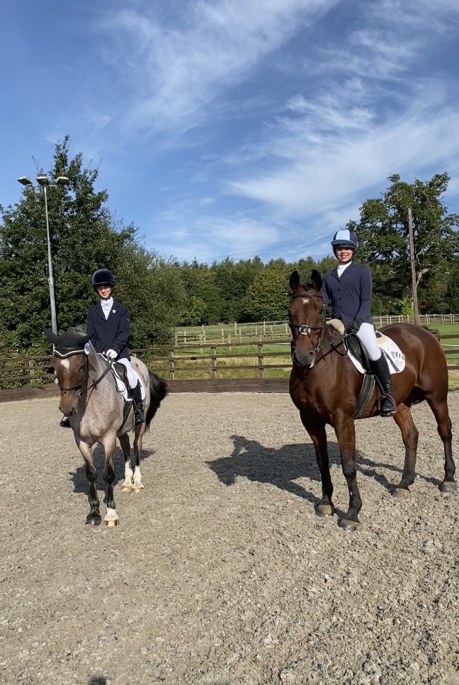 Two girls riding horses