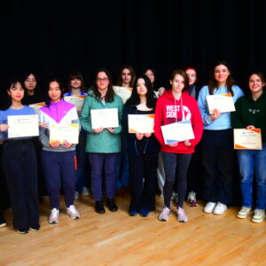 Sixth Form girls holding up certificates