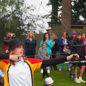 Sophie pulling back a bow