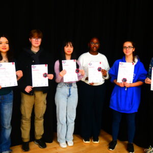 Smiling girls holding up certificates