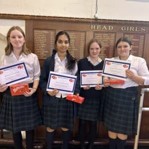 Fours girls smiling holding up certificates